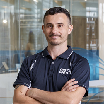  Personal trainer Albert Gariev smiling with arms crossed in front of chest